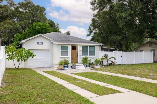 view of front of property with a garage and a front lawn