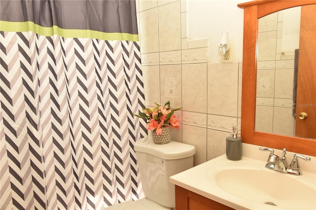 bathroom with a shower with shower curtain, tile walls, vanity, and toilet