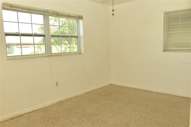 carpeted empty room featuring a healthy amount of sunlight