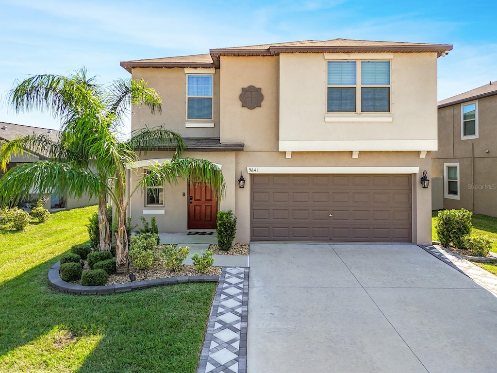 view of front of house with a front yard and a garage