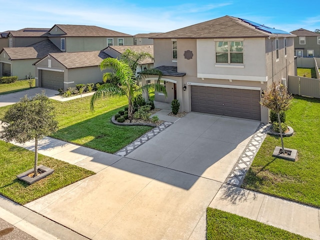 view of front of home featuring a front yard and a garage