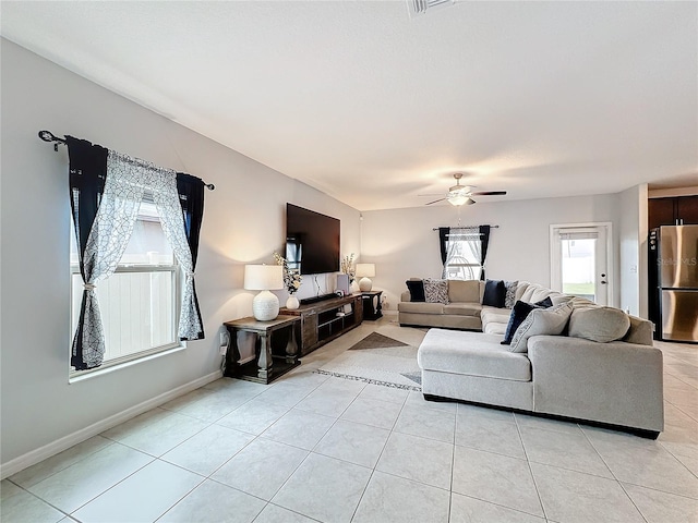 living room featuring ceiling fan and light tile patterned floors