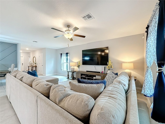 living room featuring ceiling fan and light tile patterned flooring