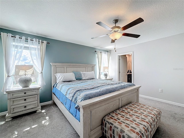 carpeted bedroom with a textured ceiling and ceiling fan