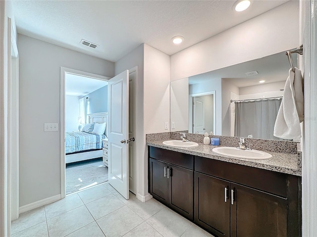 bathroom featuring vanity, a textured ceiling, and tile patterned flooring