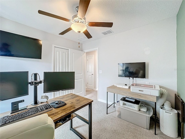 carpeted living room featuring a textured ceiling and ceiling fan