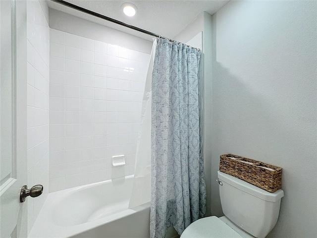 bathroom with shower / bath combo and toilet