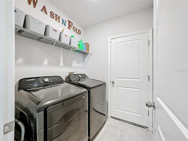 washroom featuring independent washer and dryer and light tile patterned flooring