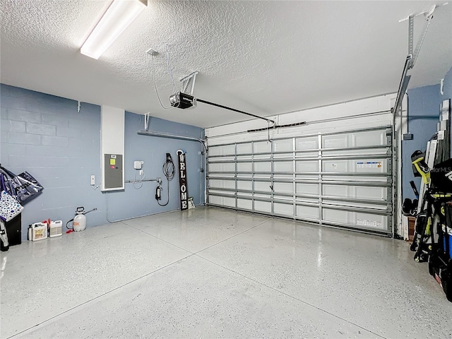 garage with a garage door opener and electric panel