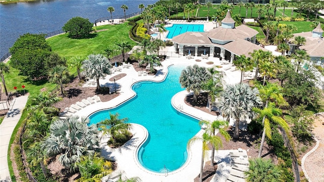 view of swimming pool with a patio and a water view