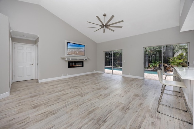 unfurnished living room featuring light wood-type flooring, ceiling fan, and high vaulted ceiling