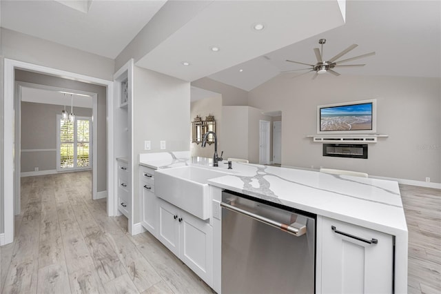 kitchen with white cabinetry, light stone counters, lofted ceiling, ceiling fan, and stainless steel dishwasher