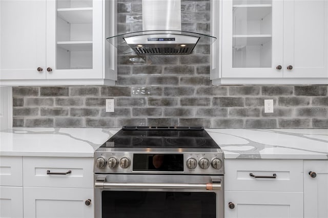 kitchen with range hood, white cabinets, and stainless steel range