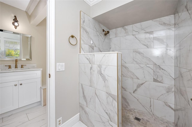 bathroom featuring vanity and tiled shower