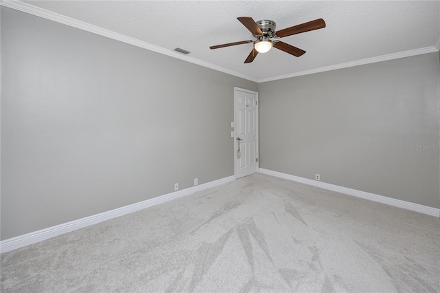 carpeted spare room featuring ceiling fan, crown molding, and a textured ceiling