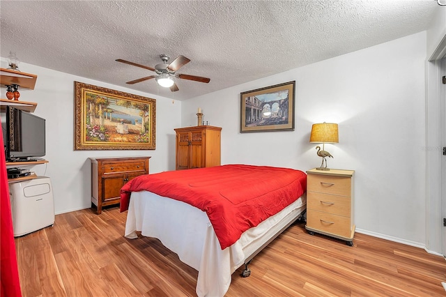 bedroom featuring ceiling fan, a textured ceiling, and hardwood / wood-style floors