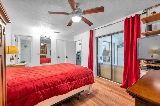 bedroom featuring light wood-type flooring, ceiling fan, and a textured ceiling