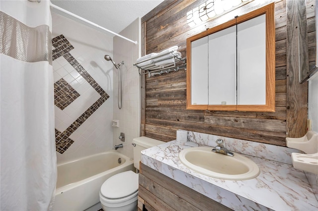 full bathroom featuring shower / bath combination with curtain, vanity, wooden walls, and toilet