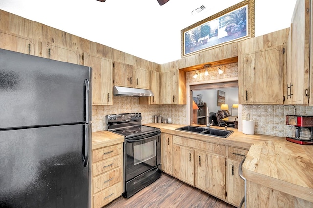 kitchen featuring light hardwood / wood-style floors, electric range, wood counters, sink, and stainless steel fridge