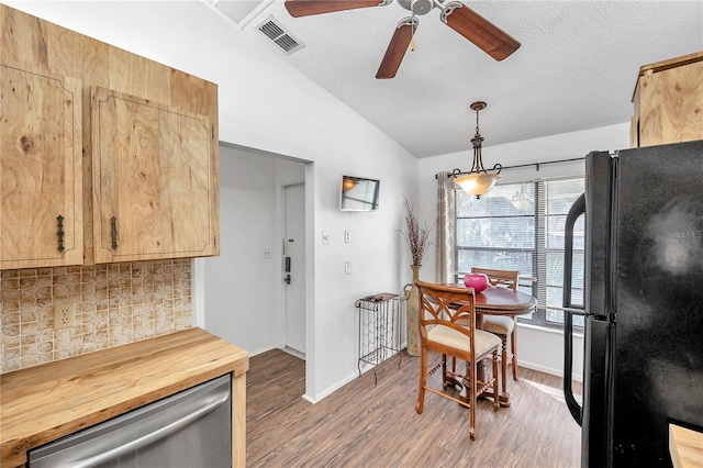 kitchen featuring light hardwood / wood-style floors, backsplash, pendant lighting, black refrigerator, and ceiling fan