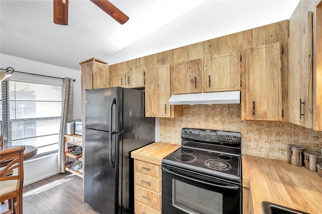 kitchen with dark hardwood / wood-style floors, tasteful backsplash, vaulted ceiling, black appliances, and ceiling fan