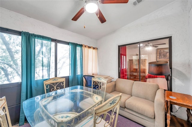 dining room with carpet, lofted ceiling, and ceiling fan