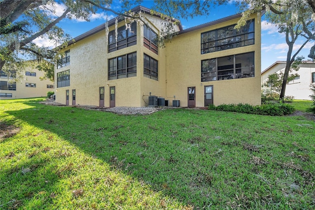 exterior space with a lawn and central air condition unit