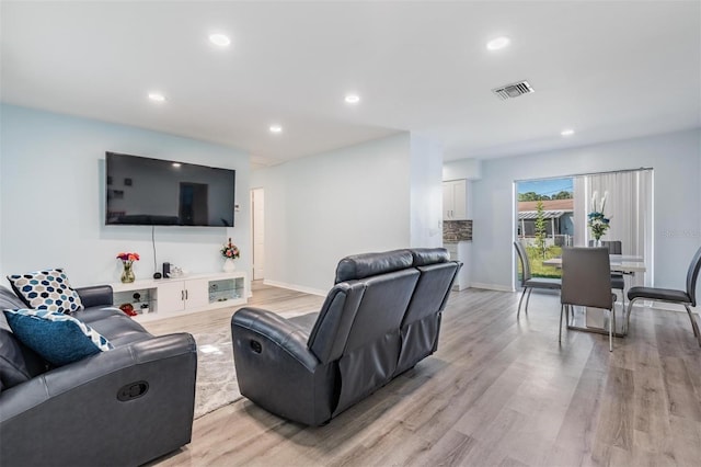 living room with light hardwood / wood-style flooring