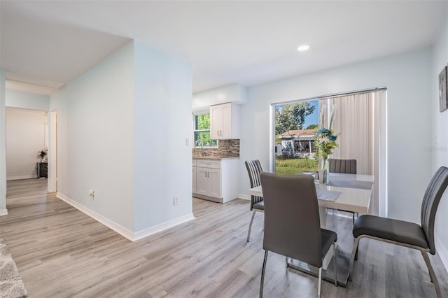 dining room featuring light wood-type flooring and sink