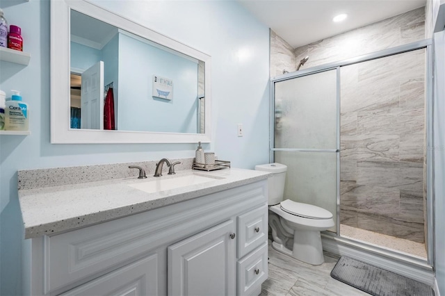 bathroom featuring walk in shower, vanity, and toilet