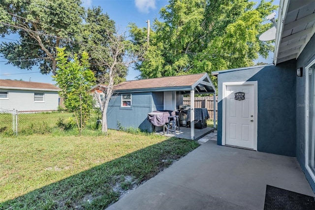 view of yard with a patio and a storage shed