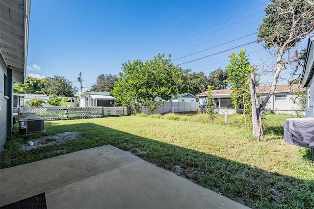 view of yard with cooling unit and a patio area