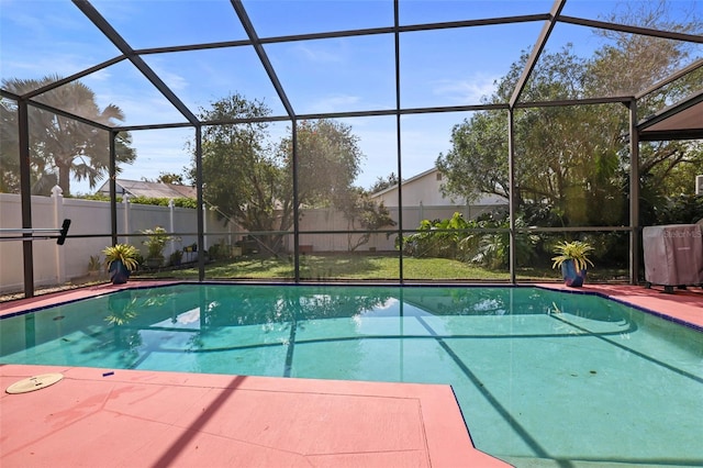 view of swimming pool with glass enclosure