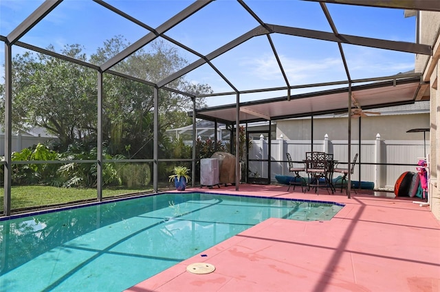 view of swimming pool featuring glass enclosure and a patio area