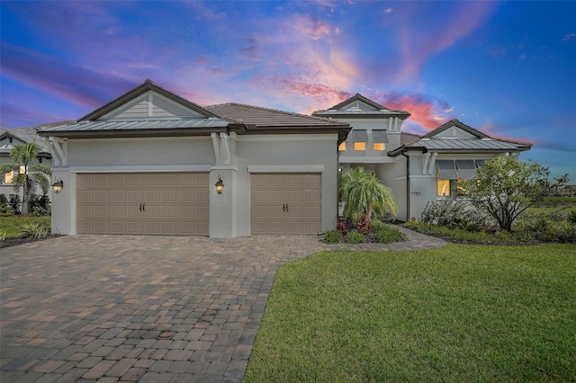 view of front of house with a lawn and a garage