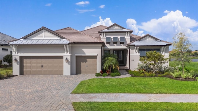 view of front of house featuring a garage and a front lawn