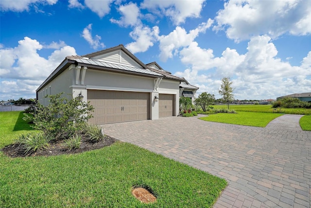 view of front of house with a front yard and a garage