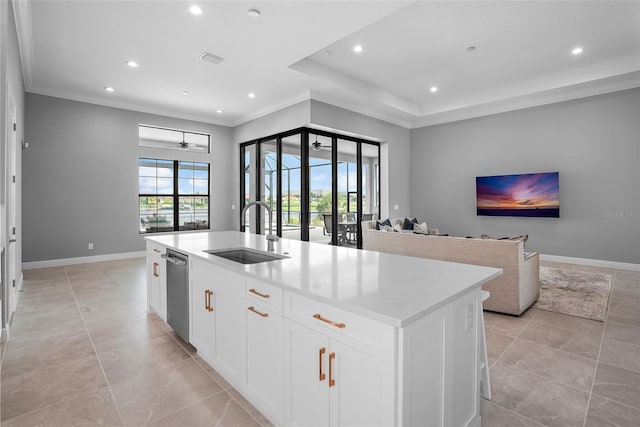 kitchen with a center island with sink, sink, stainless steel dishwasher, ceiling fan, and white cabinetry