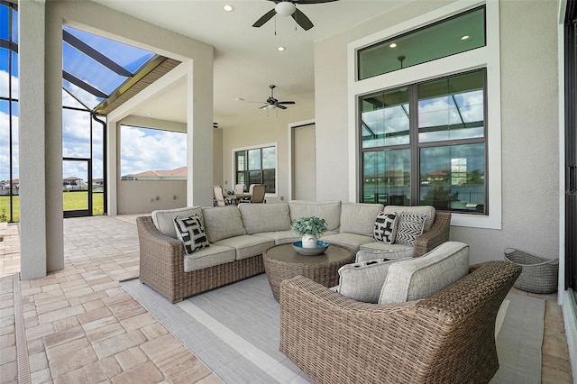 view of patio with ceiling fan and a lanai