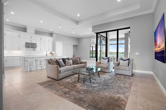 living room with ceiling fan, light tile patterned floors, and crown molding