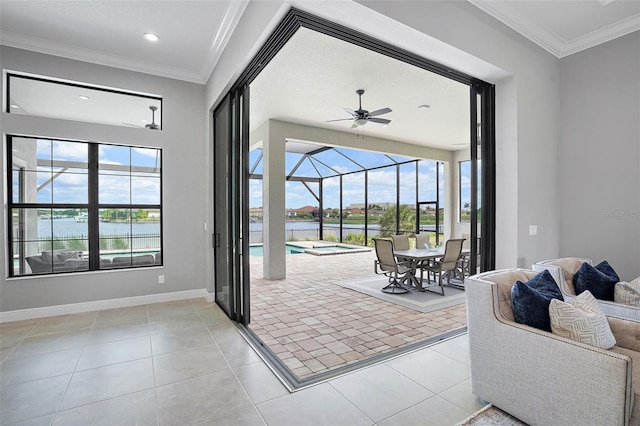 doorway to outside featuring light tile patterned floors, a water view, plenty of natural light, and ceiling fan