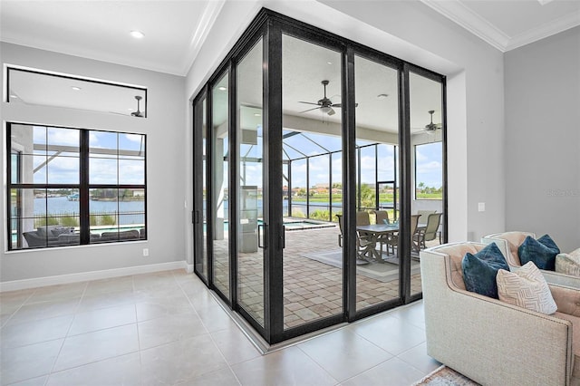 doorway to outside with plenty of natural light, ceiling fan, a water view, and ornamental molding