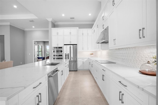 kitchen featuring light stone countertops, decorative backsplash, stainless steel appliances, sink, and white cabinetry