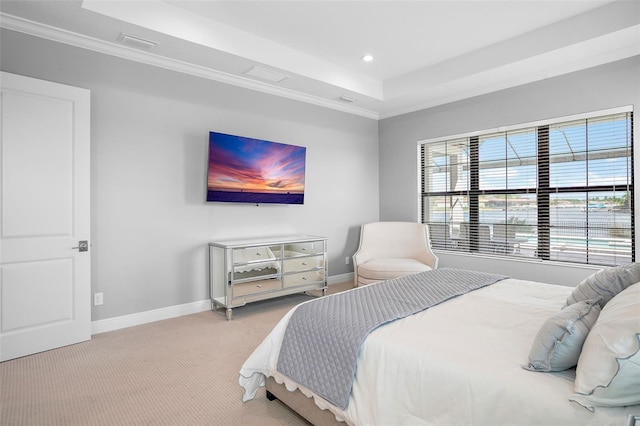 bedroom with a raised ceiling, light colored carpet, and ornamental molding