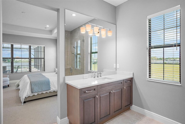 bathroom featuring tile patterned flooring, vanity, and a shower with door