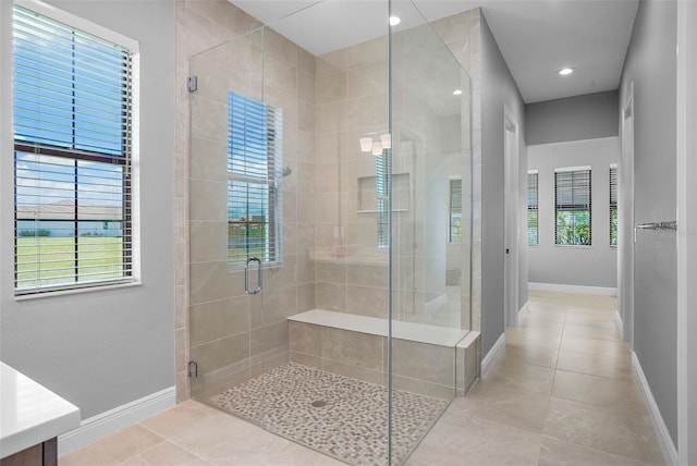 bathroom featuring tile patterned floors, vanity, and an enclosed shower