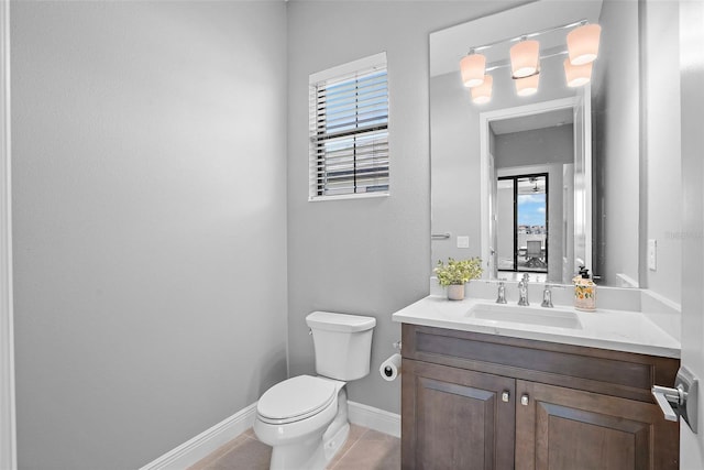 bathroom with tile patterned flooring, vanity, and toilet