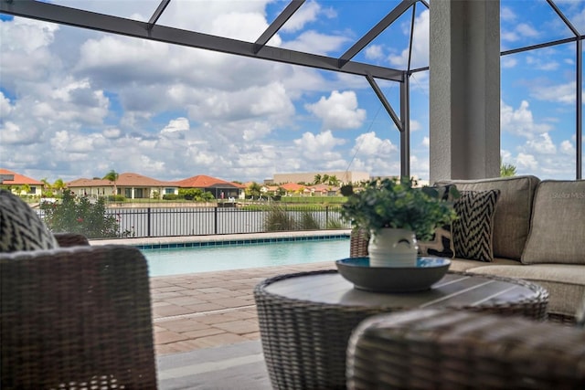 view of swimming pool with a patio area, a water view, and glass enclosure