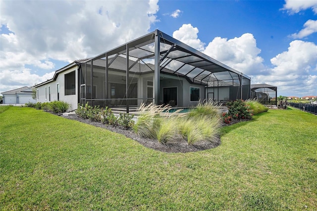 back of house with a yard and a lanai