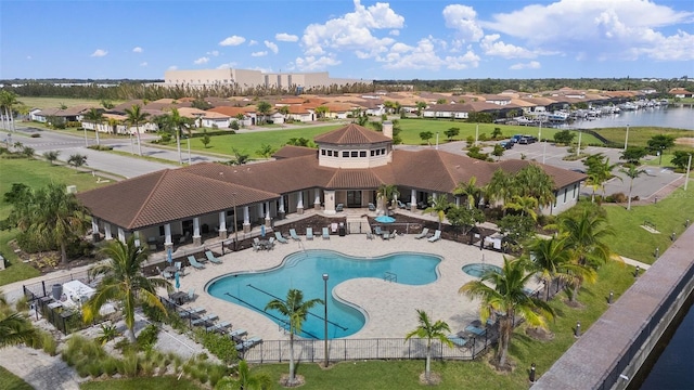 view of swimming pool featuring a patio area and a water view